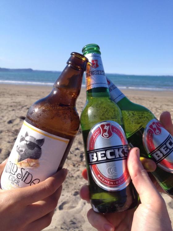Drinks on the beach to cheers the first swim of the season